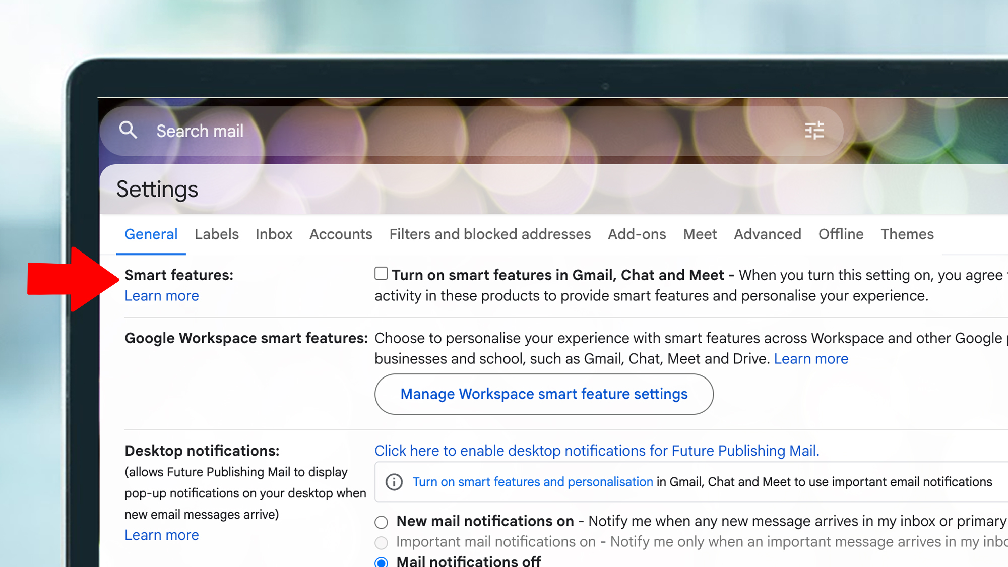 A laptop screen showing Gmail settings and the Smart features option