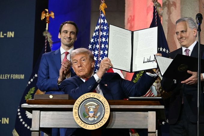 US President Donald Trump displays an executive order on artificial intelligence he signed at the 
