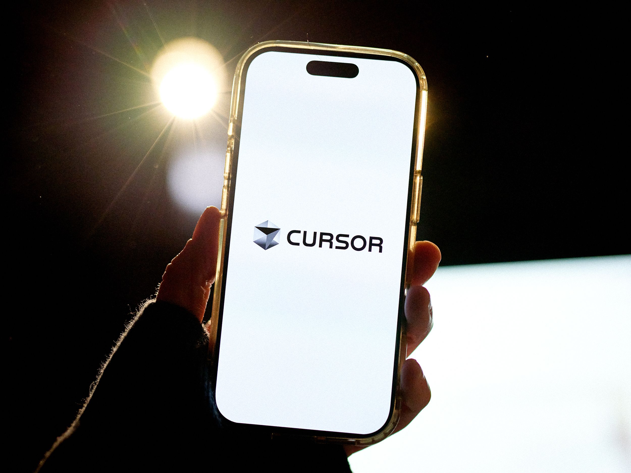 The Cursor logo arranged on a smartphone in New Hyde Park New York US on Thursday Nov. 20 2025. Cursor an artificial...